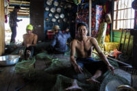 repairing fishing nets - tonle sap, cambodia